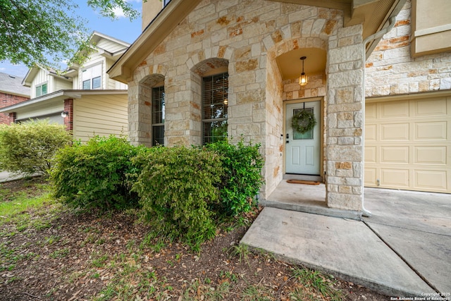 10228 Ancient Anchor, San Antonio, TX 78245 - entrance to property with stone siding, a garage, a chimney, and concrete driveway