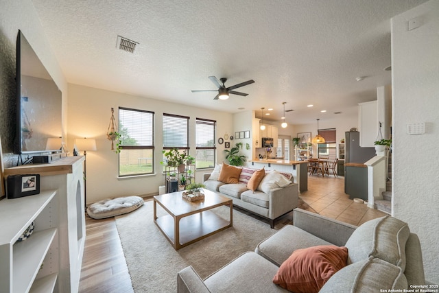 10228 Ancient Anchor, San Antonio, TX 78245 - living area with ceiling fan, a textured ceiling, light wood-style floors, and recessed lighting