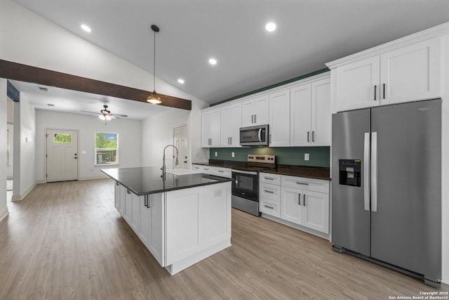 712 Gilmer, Kerrville, TX 78028 - kitchen with appliances with stainless steel finishes, a sink, dark countertops, light wood finished floors, and recessed lighting
