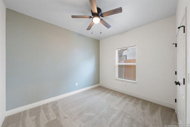 712 Gilmer, Kerrville, TX 78028 - unfurnished room with light colored carpet, baseboards, and a ceiling fan