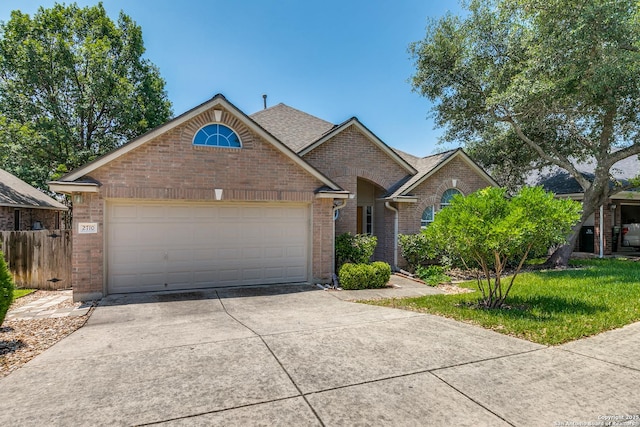 2710 Trinity Rdg, San Antonio, TX 78261 - view of front facade featuring brick siding, concrete driveway, a garage, and a shingled roof