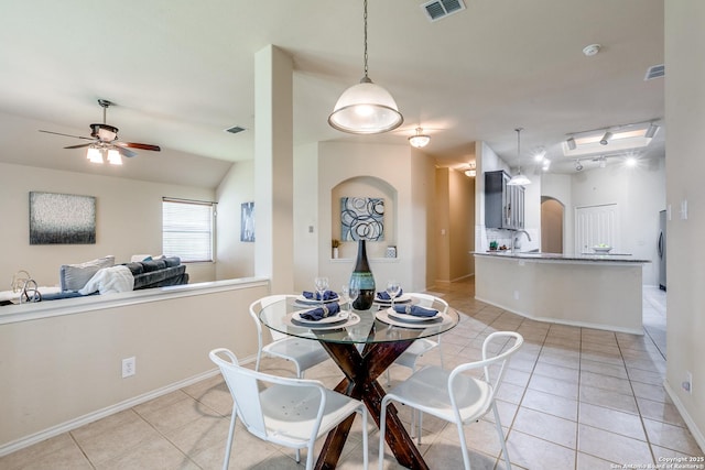 2710 Trinity Rdg, San Antonio, TX 78261 - dining room with light tile patterned floors, arched walkways, a ceiling fan, baseboards, and lofted ceiling