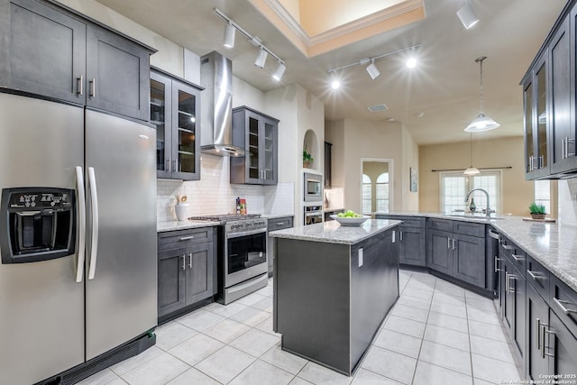 2710 Trinity Rdg, San Antonio, TX 78261 - kitchen featuring appliances with stainless steel finishes, track lighting, wall chimney range hood, a peninsula, and a sink