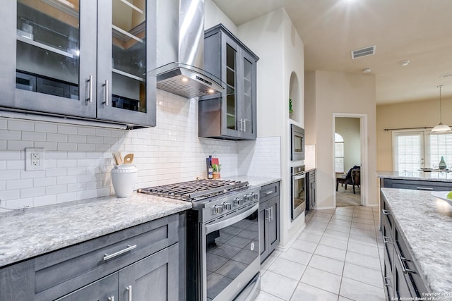 2710 Trinity Rdg, San Antonio, TX 78261 - kitchen with stainless steel appliances, wall chimney exhaust hood, tasteful backsplash, light tile patterned floors, and pendant lighting