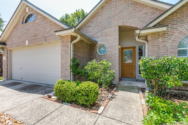 2710 Trinity Rdg, San Antonio, TX 78261 - view of exterior entry with driveway, an attached garage, and brick siding