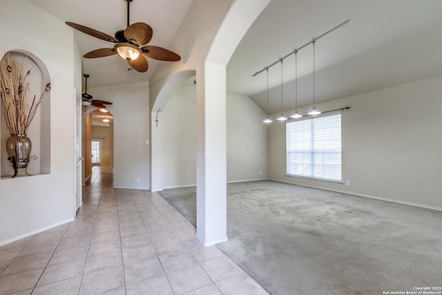 2710 Trinity Rdg, San Antonio, TX 78261 - unfurnished room featuring arched walkways, ceiling fan, vaulted ceiling, baseboards, and light tile patterned flooring