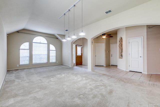 2710 Trinity Rdg, San Antonio, TX 78261 - carpeted empty room with arched walkways, ceiling fan, lofted ceiling, baseboards, and tile patterned flooring