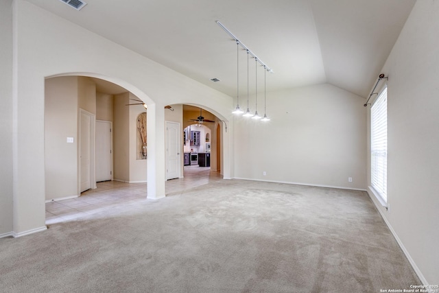 2710 Trinity Rdg, San Antonio, TX 78261 - unfurnished living room featuring arched walkways, vaulted ceiling, a ceiling fan, plenty of natural light, and light carpet