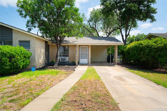 7414 Westfield Blvd, San Antonio, TX 78227 - view of front of home with brick siding, driveway, an attached carport, and a front yard