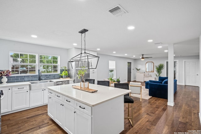 108 Bryn Mawr Dr, San Antonio, TX 78209 - kitchen featuring a sink, a kitchen breakfast bar, a center island, white cabinets, and recessed lighting
