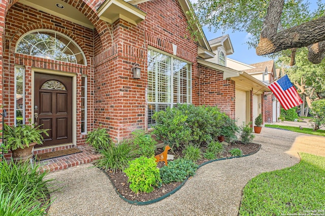28 Cutter Grn, San Antonio, TX 78248 - property entrance featuring brick siding, a garage, and concrete driveway