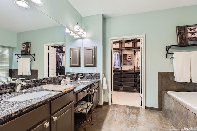 28 Cutter Grn, San Antonio, TX 78248 - bathroom with a walk in closet, double vanity, baseboards, and tiled bath