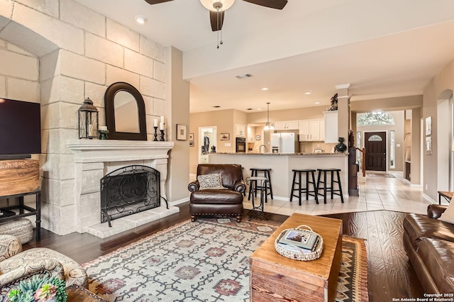 28 Cutter Grn, San Antonio, TX 78248 - living area with ceiling fan, light wood finished floors, baseboards, a tile fireplace, and recessed lighting