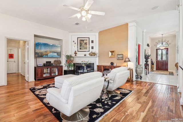 8611 Torry Vw, Houston, TX 77095 - living area featuring light wood-style flooring, a fireplace, and ceiling fan