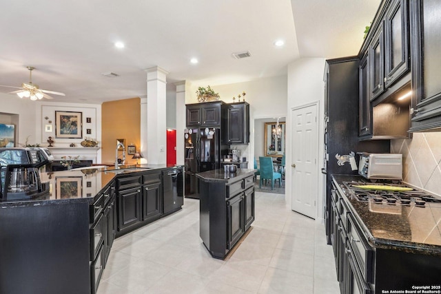 8611 Torry Vw, Houston, TX 77095 - kitchen featuring dark cabinets, a sink, black appliances, a kitchen island, and backsplash