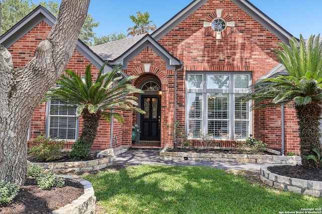 8611 Torry Vw, Houston, TX 77095 - tudor home with brick siding, a front yard, and a shingled roof