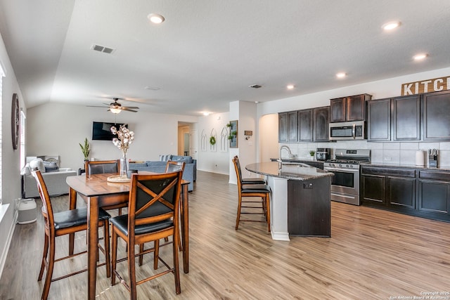 13323 Spike Rush, San Antonio, TX 78254 - kitchen with stainless steel appliances, open floor plan, a sink, baseboards, and tasteful backsplash