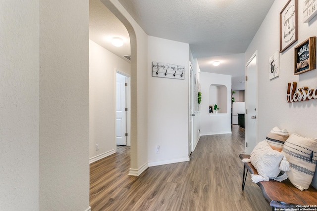 13323 Spike Rush, San Antonio, TX 78254 - corridor with arched walkways, wood finished floors, and baseboards