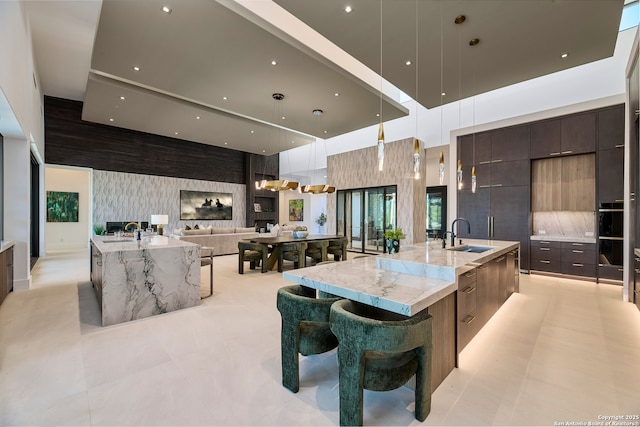 24607 Cliff Line, San Antonio, TX 78257 - kitchen with modern cabinets, a spacious island, a sink, and recessed lighting