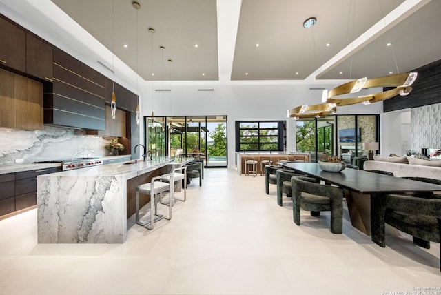 24607 Cliff Line, San Antonio, TX 78257 - kitchen featuring modern cabinets, open floor plan, light stone counters, a large island, and recessed lighting