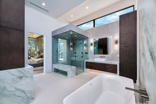 24607 Cliff Line, San Antonio, TX 78257 - ensuite bathroom with a freestanding bath, a marble finish shower, vanity, and tile patterned flooring