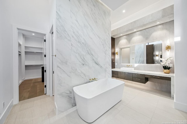 24607 Cliff Line, San Antonio, TX 78257 - full bath featuring a freestanding tub, vanity, recessed lighting, tile patterned floors, and a spacious closet