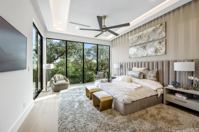 24607 Cliff Line, San Antonio, TX 78257 - bedroom featuring multiple windows, wood finished floors, recessed lighting, a tray ceiling, and ceiling fan