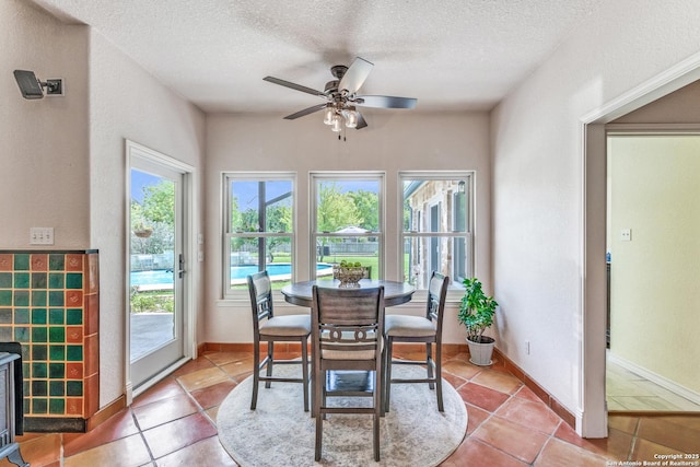 121 Maderas, Seguin, TX 78155 - dining space featuring a textured ceiling, a ceiling fan, light tile patterned floors, and baseboards