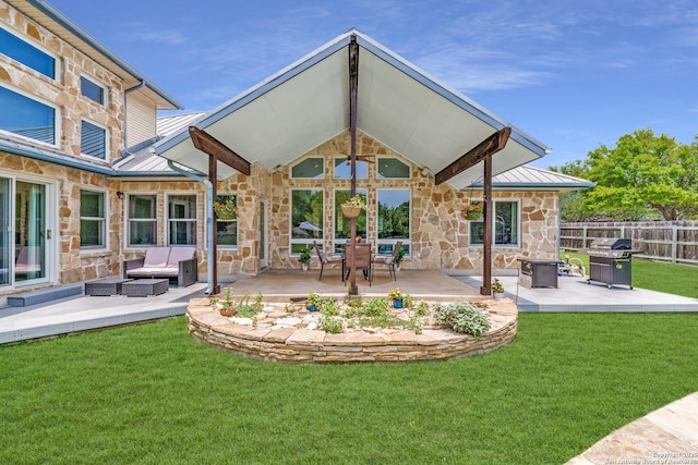 121 Maderas, Seguin, TX 78155 - back of property with stone siding, a standing seam roof, an outdoor hangout area, a patio area, and metal roof