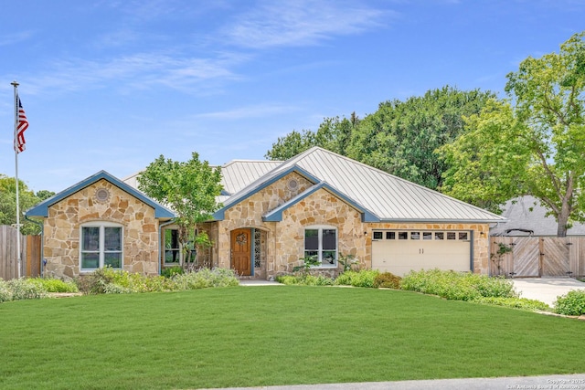 121 Maderas, Seguin, TX 78155 - view of front facade with stone siding, a standing seam roof, a garage, and driveway