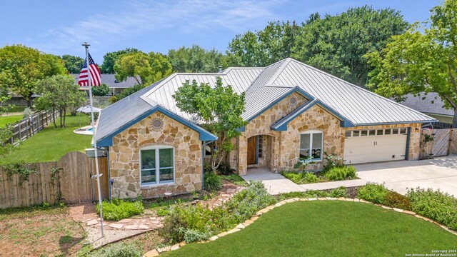 121 Maderas, Seguin, TX 78155 - view of front of property featuring stone siding, a standing seam roof, concrete driveway, a garage, and a gate