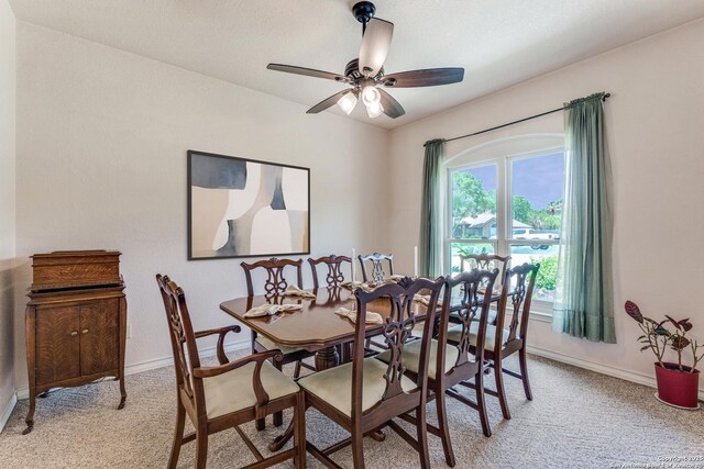 121 Maderas, Seguin, TX 78155 - dining area with light colored carpet, baseboards, and a ceiling fan