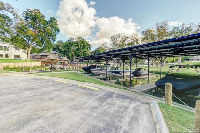 121 Maderas, Seguin, TX 78155 - uncovered parking lot featuring a dock and boat lift