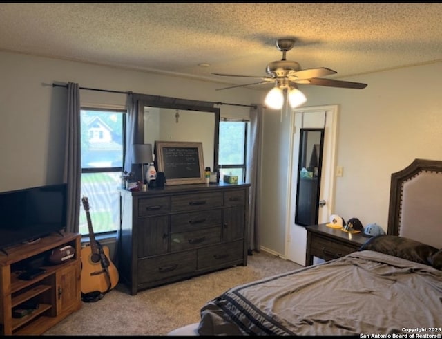 13218 Huntsman Rd, San Antonio, TX 78249 - bedroom featuring light carpet, multiple windows, a textured ceiling, and ceiling fan