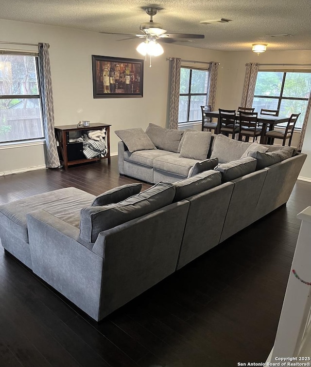 13218 Huntsman Rd, San Antonio, TX 78249 - living area featuring wood finished floors, a ceiling fan, a textured ceiling, and baseboards