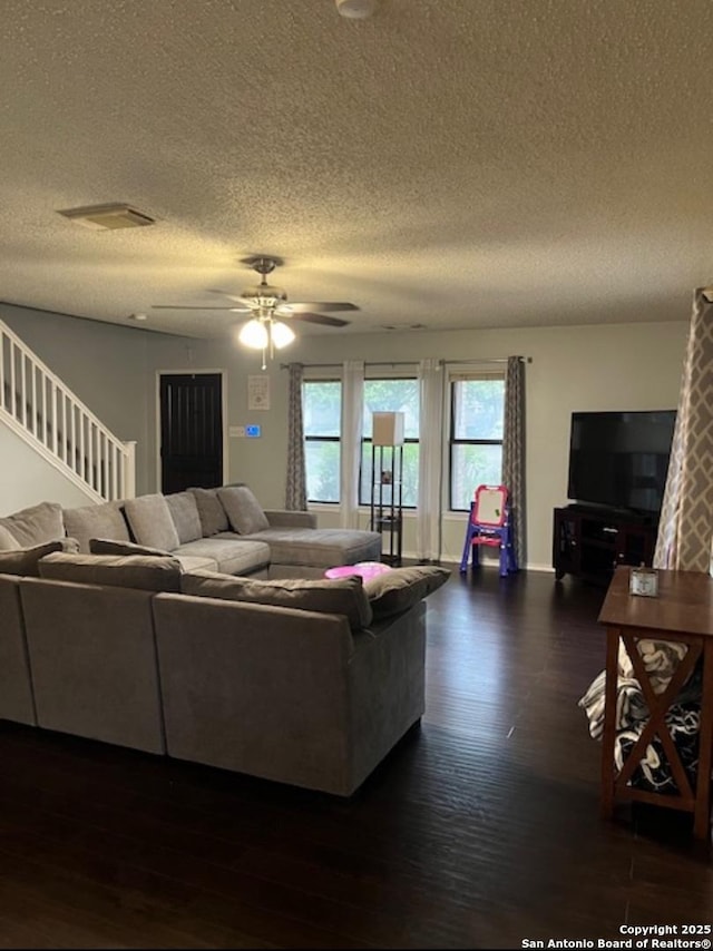 13218 Huntsman Rd, San Antonio, TX 78249 - living area featuring a textured ceiling, dark wood finished floors, a ceiling fan, stairs, and baseboards