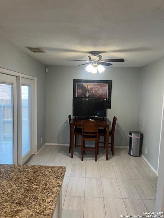 13218 Huntsman Rd, San Antonio, TX 78249 - dining room featuring a ceiling fan, baseboards, and a textured ceiling