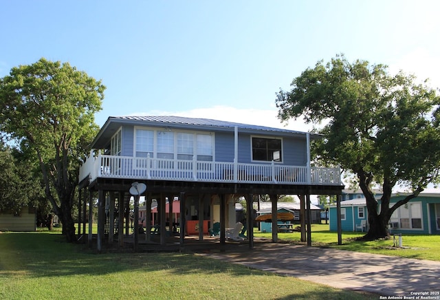38 Peggy, Palacios, TX 77465 - beach home with a front lawn, metal roof, and a carport