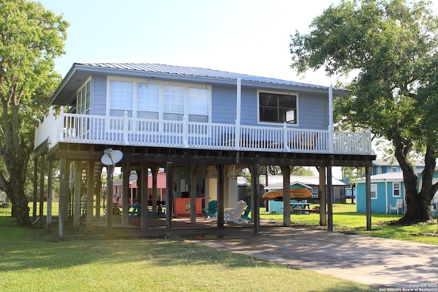 38 Peggy, Palacios, TX 77465 - coastal home with a front yard, metal roof, and a wooden deck