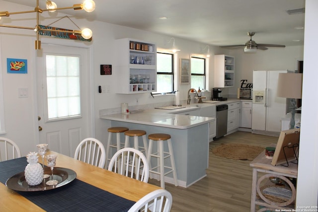 38 Peggy, Palacios, TX 77465 - kitchen featuring white fridge with ice dispenser, stainless steel dishwasher, a peninsula, and healthy amount of natural light