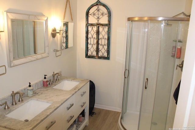 38 Peggy, Palacios, TX 77465 - full bathroom with a stall shower, double vanity, wood finished floors, and baseboards