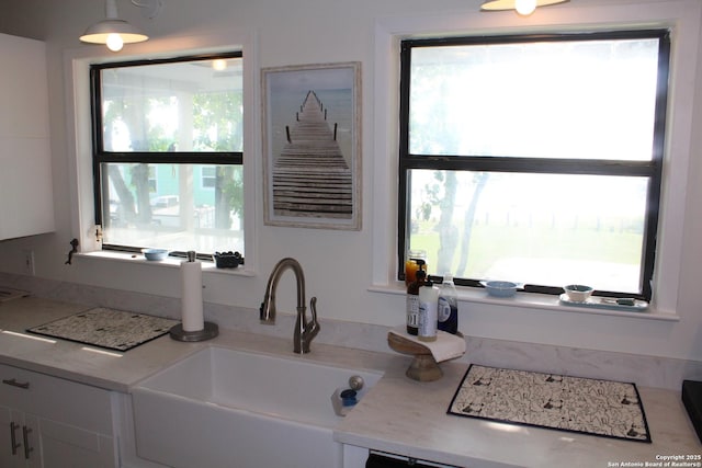 38 Peggy, Palacios, TX 77465 - kitchen featuring a sink, white cabinetry, and light countertops