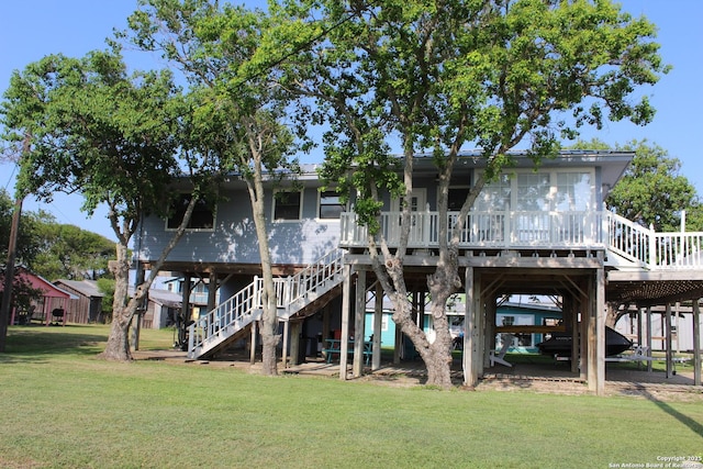 38 Peggy, Palacios, TX 77465 - back of house featuring stairway, a lawn, and a deck