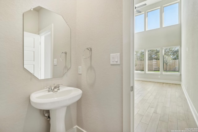1411 Arcas Way, San Antonio, TX 78245 - bathroom featuring baseboards and wood finished floors