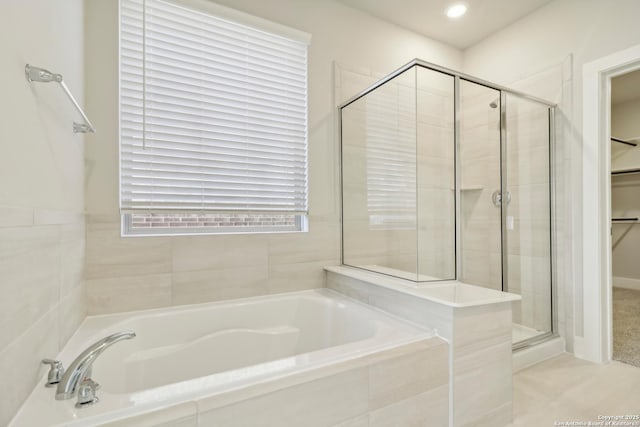 1411 Arcas Way, San Antonio, TX 78245 - bathroom with a bath, a stall shower, and a walk in closet