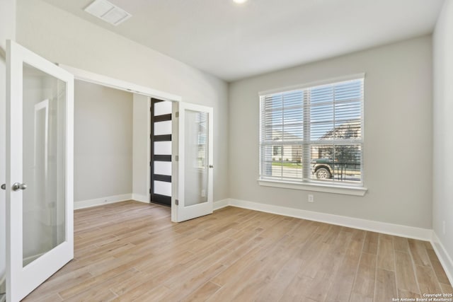 1411 Arcas Way, San Antonio, TX 78245 - empty room with french doors, light wood-type flooring, and baseboards