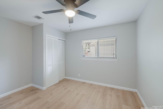 6518 Spring Hurst Dr, San Antonio, TX 78249 - unfurnished bedroom featuring light wood-type flooring, a closet, baseboards, and a ceiling fan