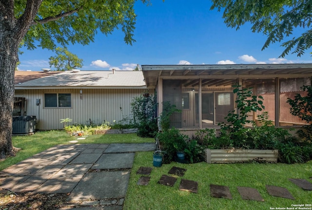 6518 Spring Hurst Dr, San Antonio, TX 78249 - view of front of house with a sunroom, a front lawn, and central air condition unit