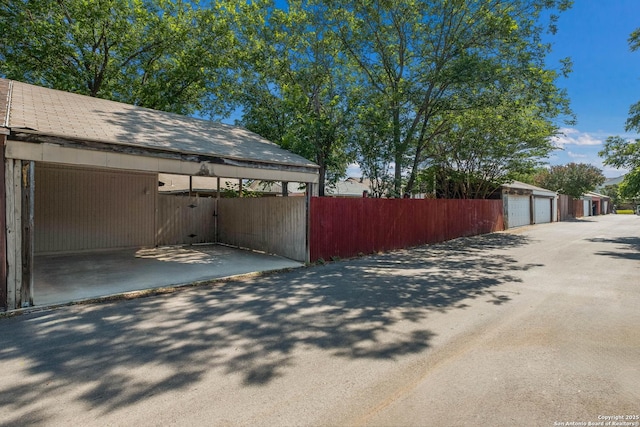 6518 Spring Hurst Dr, San Antonio, TX 78249 - view of side of home featuring an outdoor structure and driveway