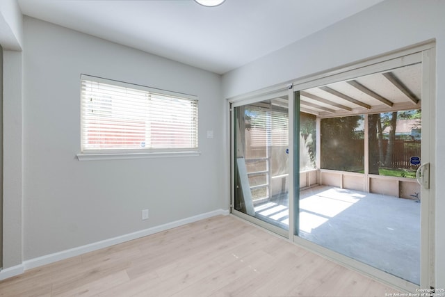 6518 Spring Hurst Dr, San Antonio, TX 78249 - spare room featuring wood finished floors, healthy amount of natural light, and baseboards